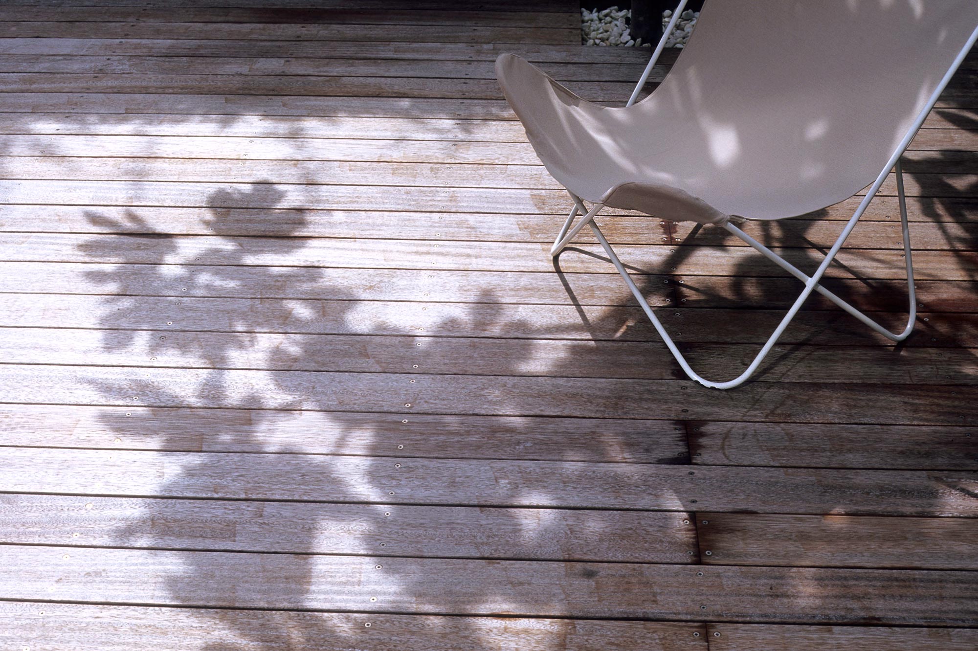 Fulham Courtyard detail of chair on decking - James ALdridge Landscape and Garden Design